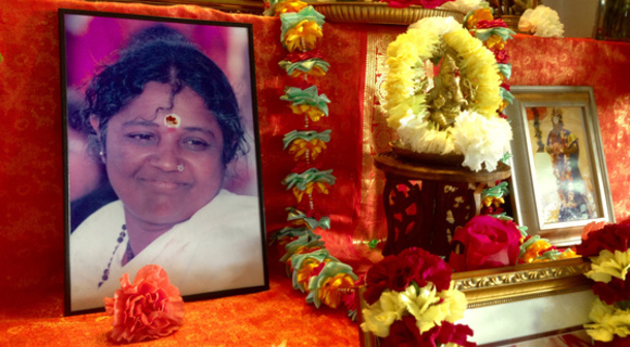 Amma's photo on altar with Ganesh murthi and fresh flowers