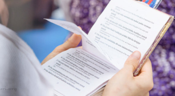 Person holding their archana book