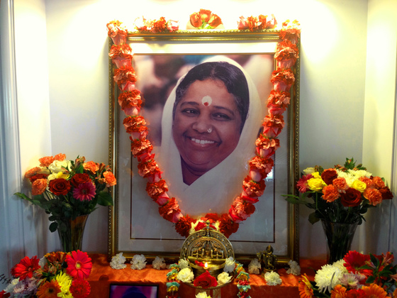 Altar with Amma's picture, garland and flowers