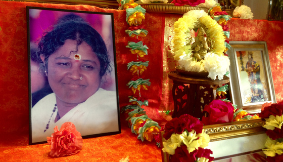 Amma's photo with Ganesha murti and flowers