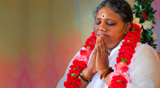 Amma praying and wearing rose garland