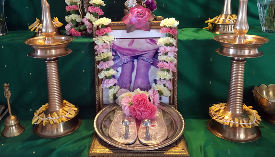 Altar with Amma's padam picture, garland and flowers