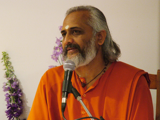 Swami Ramakrishnananda speaking at a microphone