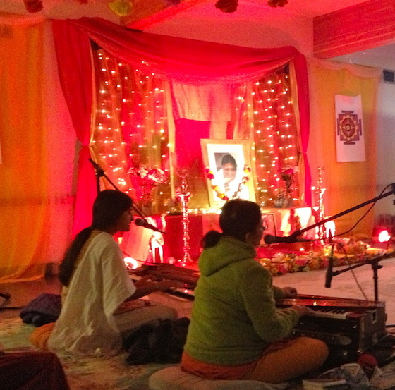 Two people singing Bhajans at the altar
