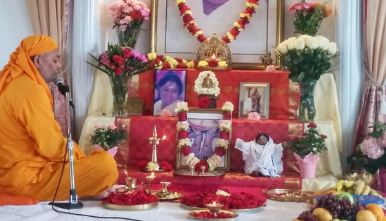 Dayamrita Chaitanya sitting near altar