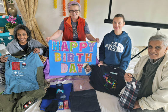 Volunteers assembling homeless care packages for Amma's birthday