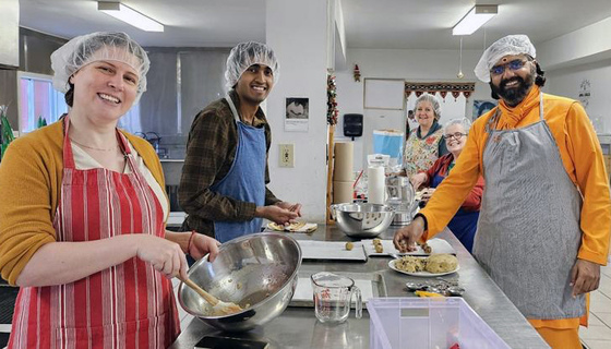 Ramanandamrita Swamiji and other volunteers making cookies for a homeless shelter