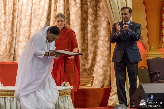 Amma accepting the congressional commendation from Congressman Krishnamoorthi