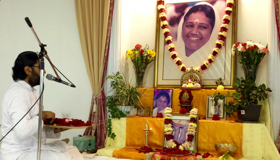 Br. Ramanand offering flower petals at Amma's feet