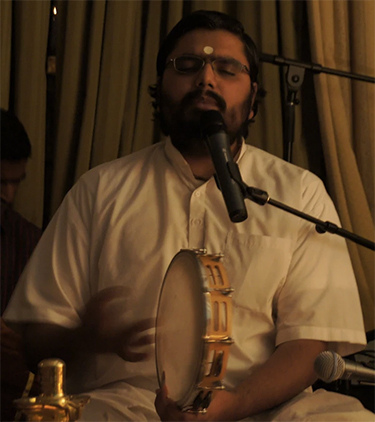 Brahmachari Ramanand playing tambourine