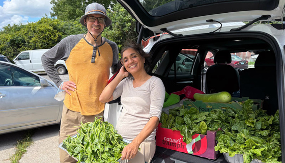 Volunteers with freshly picked veggies