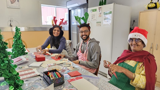 Volunteers filling out holiday cards for needy seniors