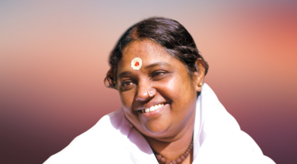 Amma in white sari, smiling, sunset in background