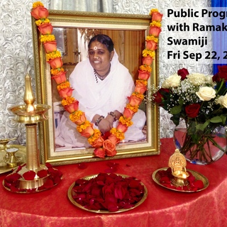 Altar with brass lamp, and Amma's photo, beautifully decorated with flowers