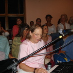 Amritapriya playing keyboard during bhajans.