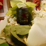 Dark stone Shiva Lingam with powders and flower petals