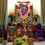 Photo of altar with Amma's picture, garlands and fresh flowers