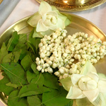 Jasmine and lotus flowers and bilva leaves on dish