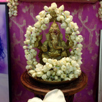 Brass Ganesha murti with jasmine garland