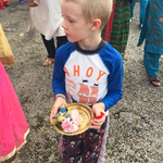 Boy in procession with Krishna murtis