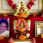 Amma's photo and Ganesh murti with fresh flower garlands