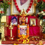 Altar with photo of Amma's feet, beautifully decorated with flowers