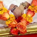 Close-up of Amma's hands with rose garland