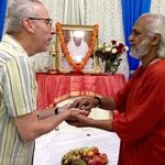 Swami Ramakrishnananda giving prasad to a devotee