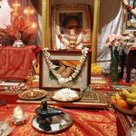 Altar with black stone Shiva lingam and Nandi and photos of Amma