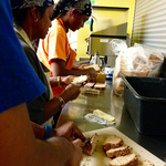 Volunteers buttering bread