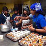 Youth making bowls of granola with peaches
