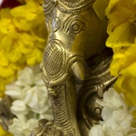 Ganesh murti with marigold and jasmine garlands