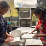 Youth preparing boxed lunches