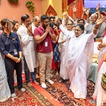 Amma on stage with devotees leaving after the program - raised arms for Mata Rani ki Jai