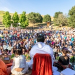 Amma's satsang facing audience all seated around in the meadow