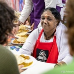 Amma serving dinner wearing apron