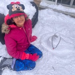 Child next to Siva Lingam they made out of snow garlanded with a rudraksha mala