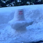 Siva Lingam made out of snow with kumkum and chandan markings