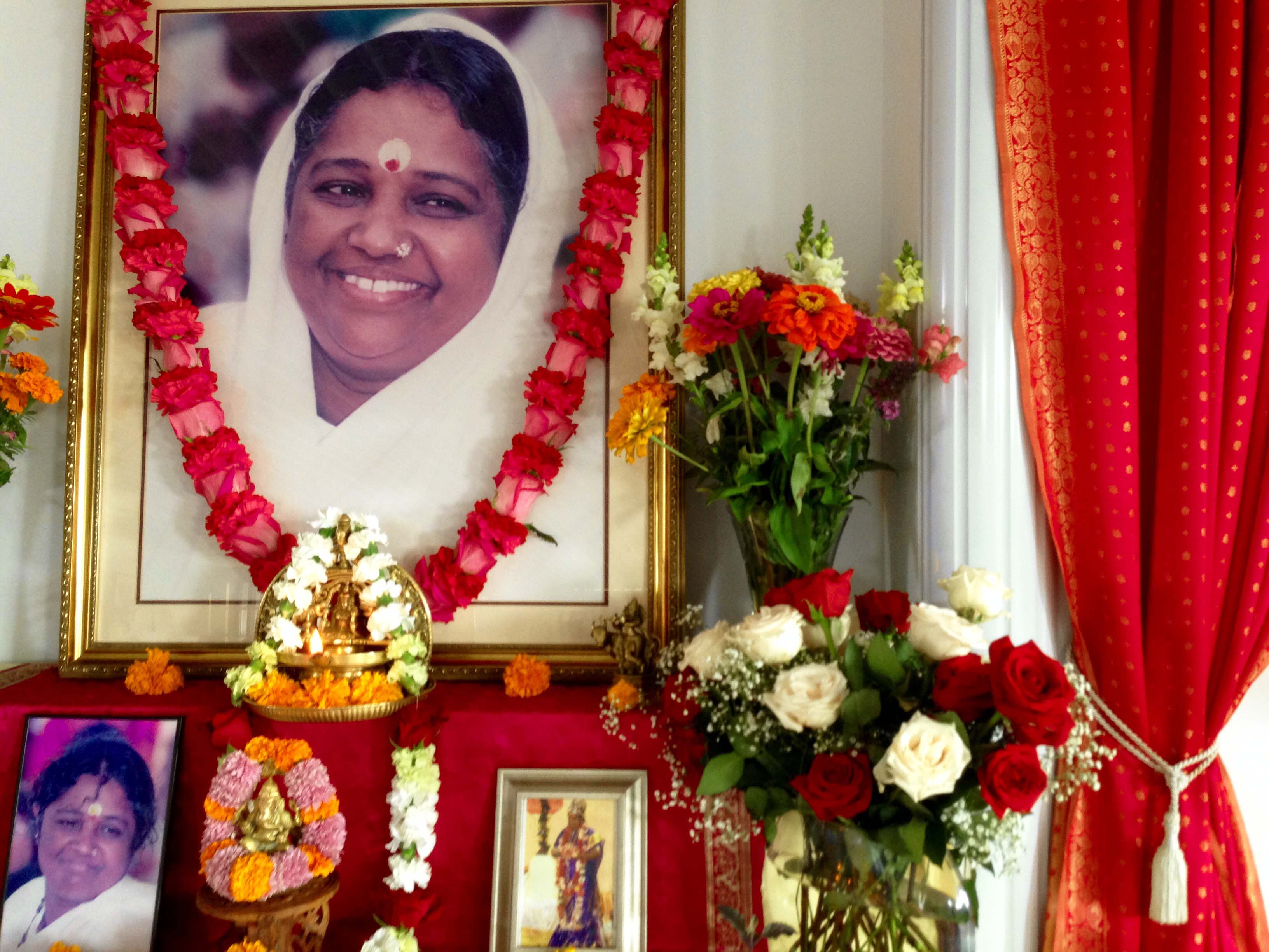 Amma's photo on altar decorated with fresh flowers