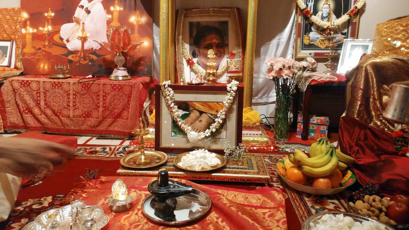 Altar with Shiva Lingam, Nandi and Amma's photos, garlanded with fresh flowers