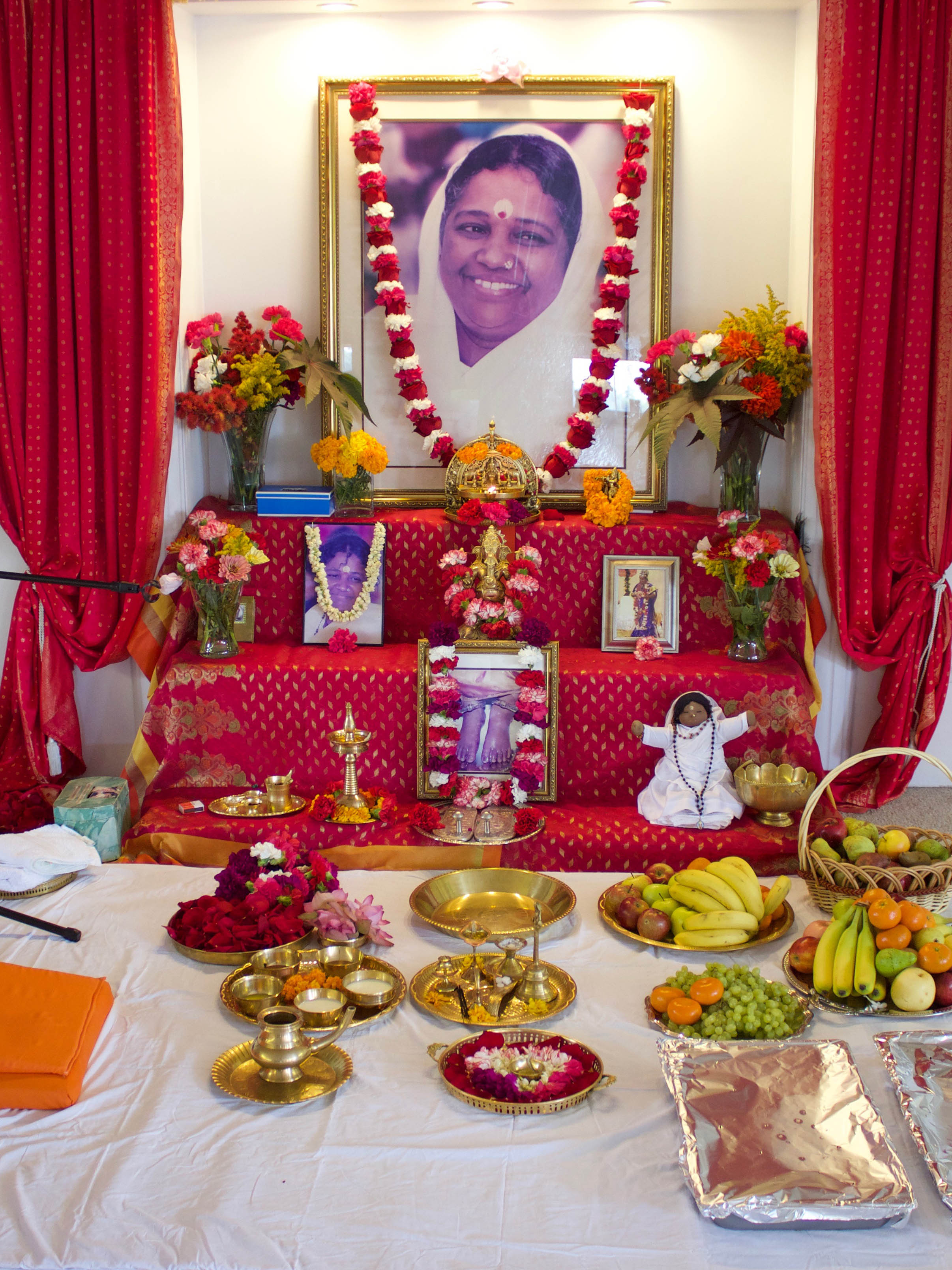Altar with Amma's picture and garlands of fresh flowers