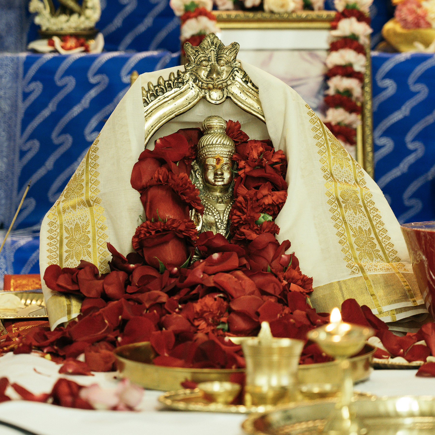 Ayyappa statue with garland of red flowers