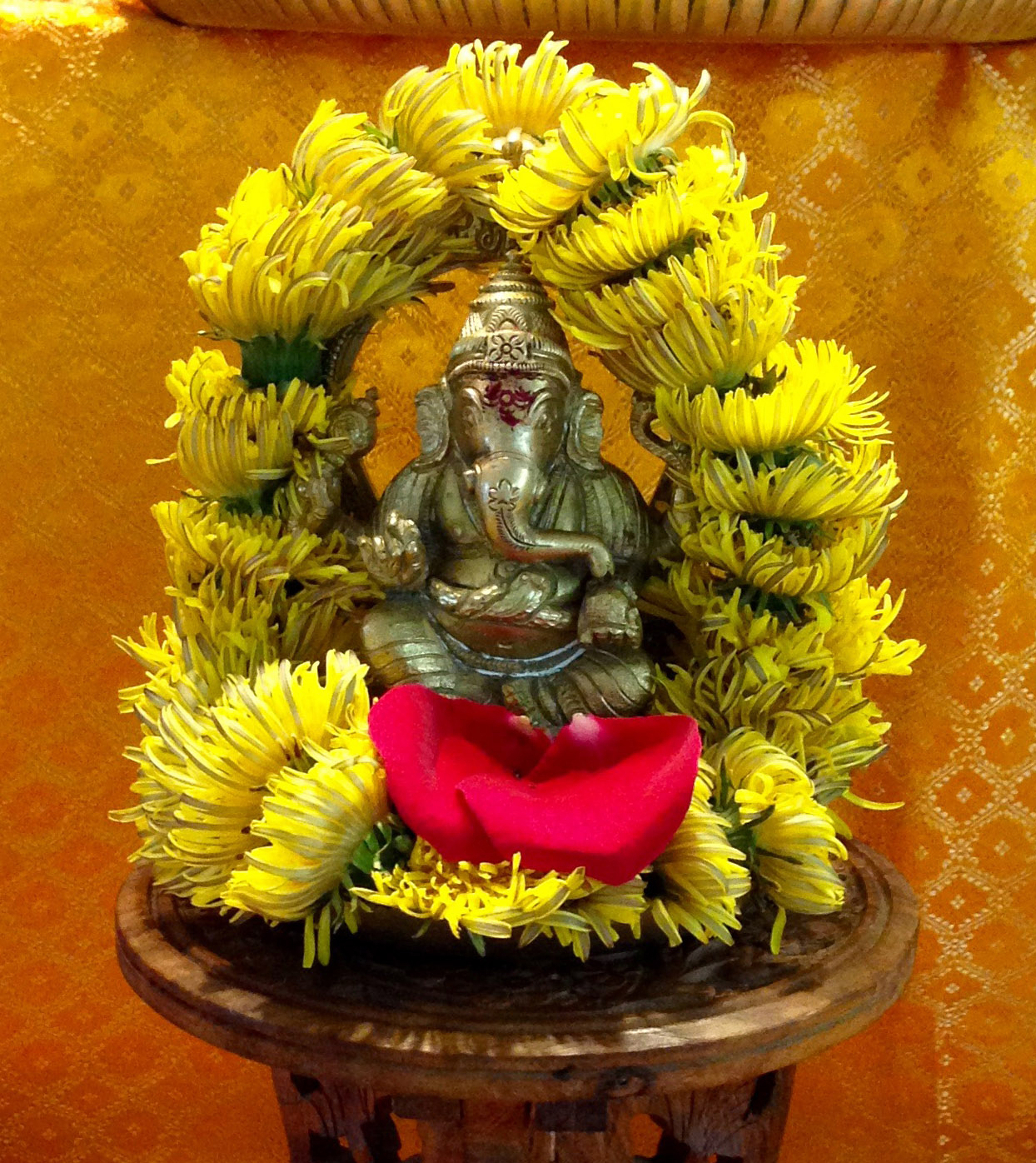 Ganesha murti with dandelion garland