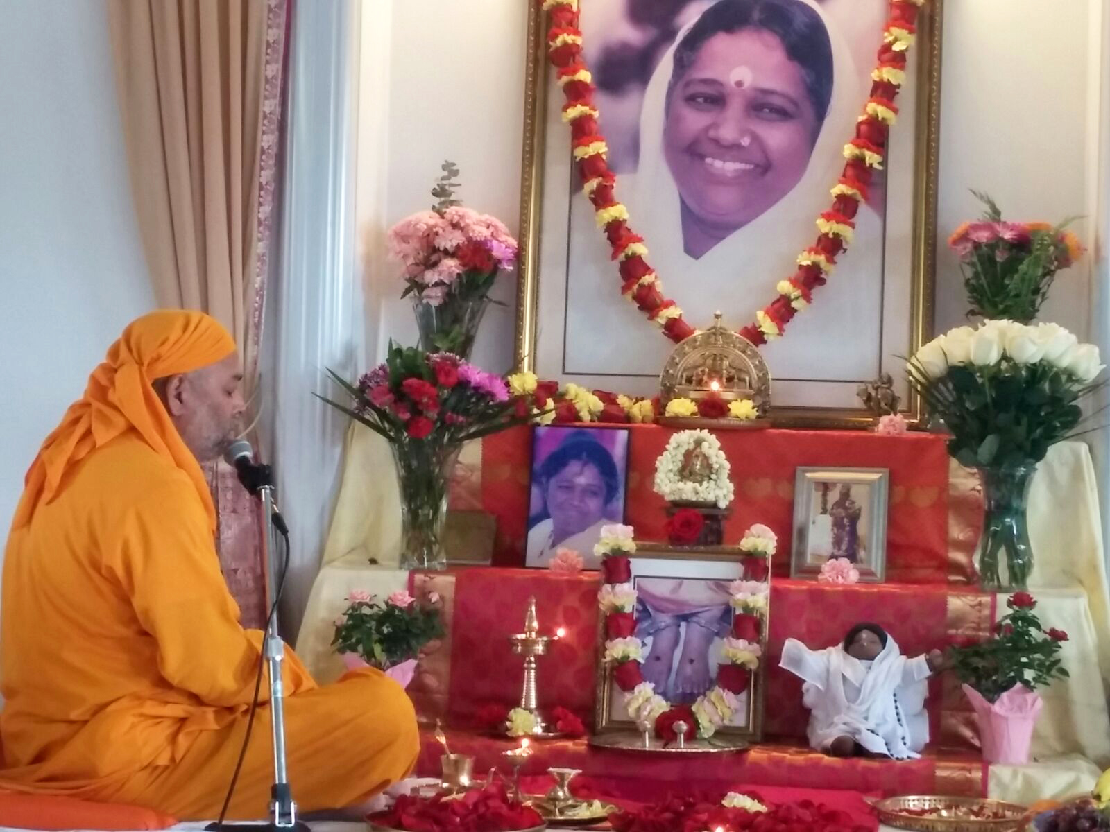 Dayamrita Chaitanya sitting by altar