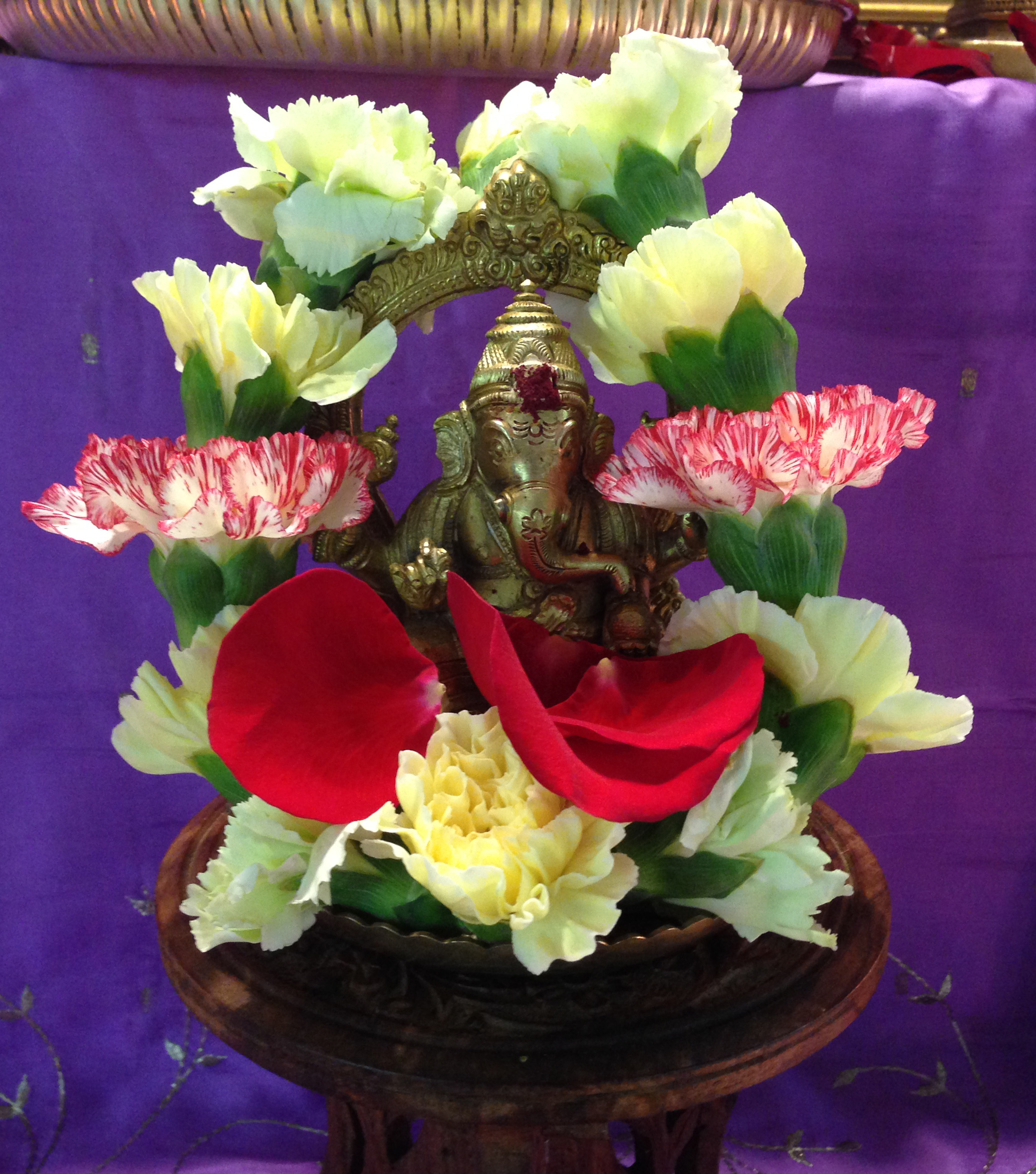 Ganesha murti with fresh flower wreath