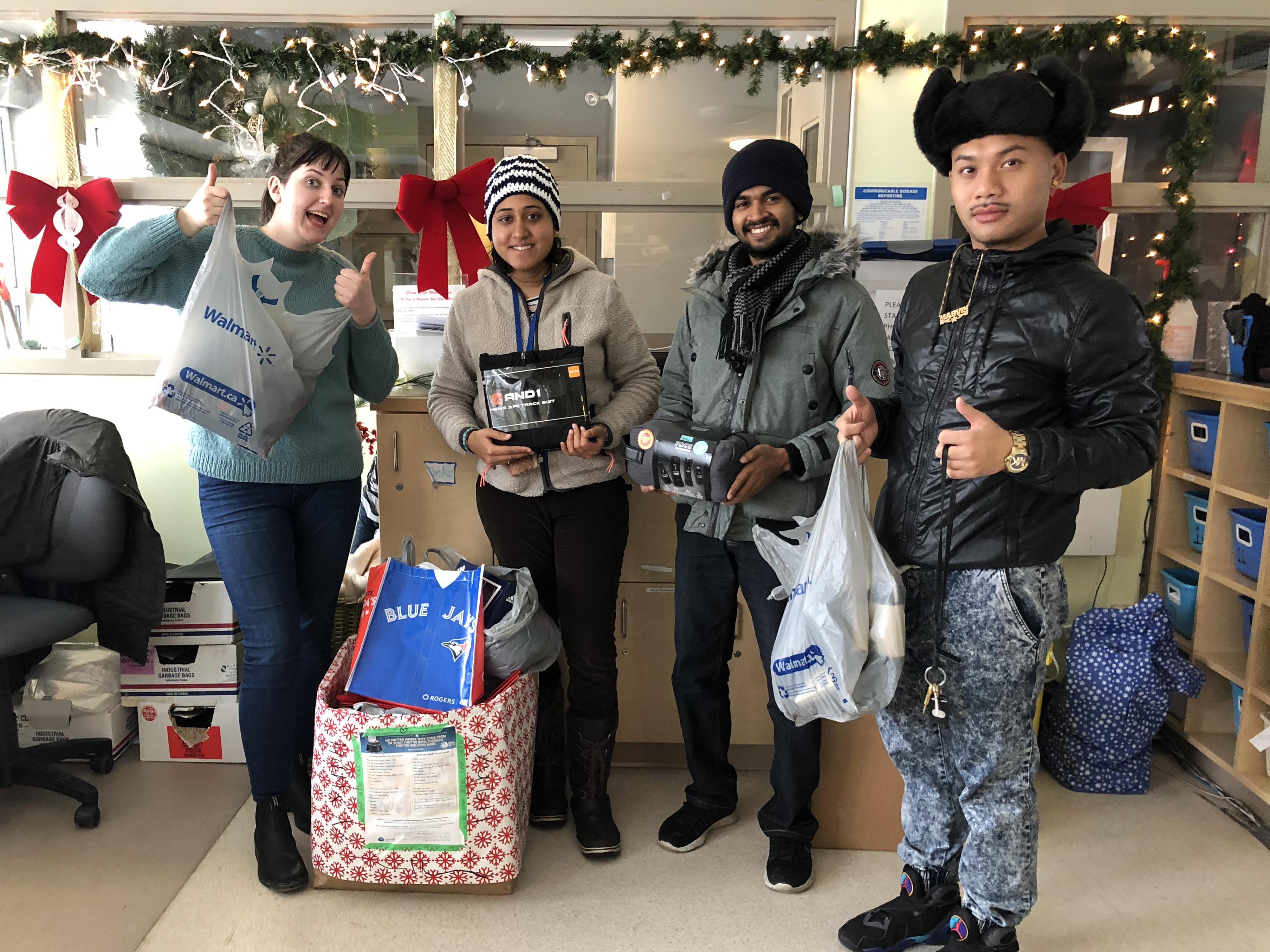 AYUDH Toronto members giving donations to Youth Without Shelter staff