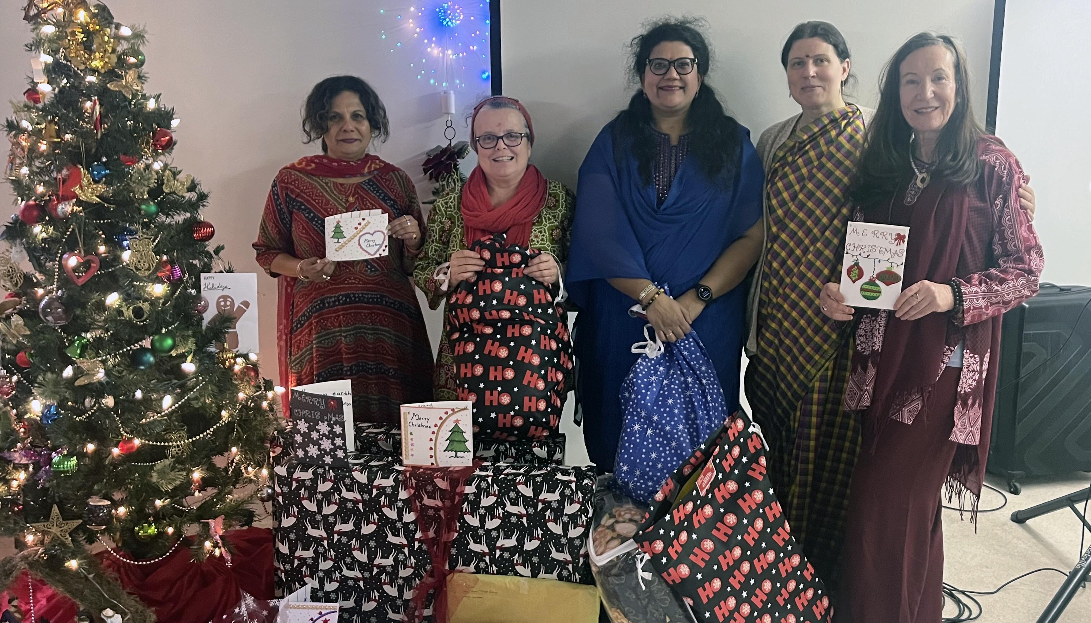Volunteers with wrapped holiday gifts for Bennett Centre seniors - Dec 2023