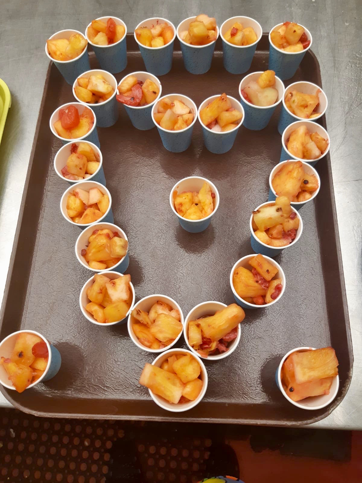 Bowls of fruit salad arranged in a heart