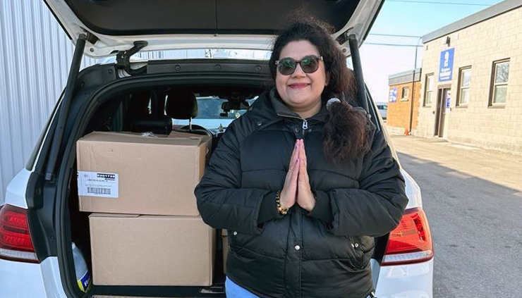 Amma Canada volunteer with food donations loaded in her car