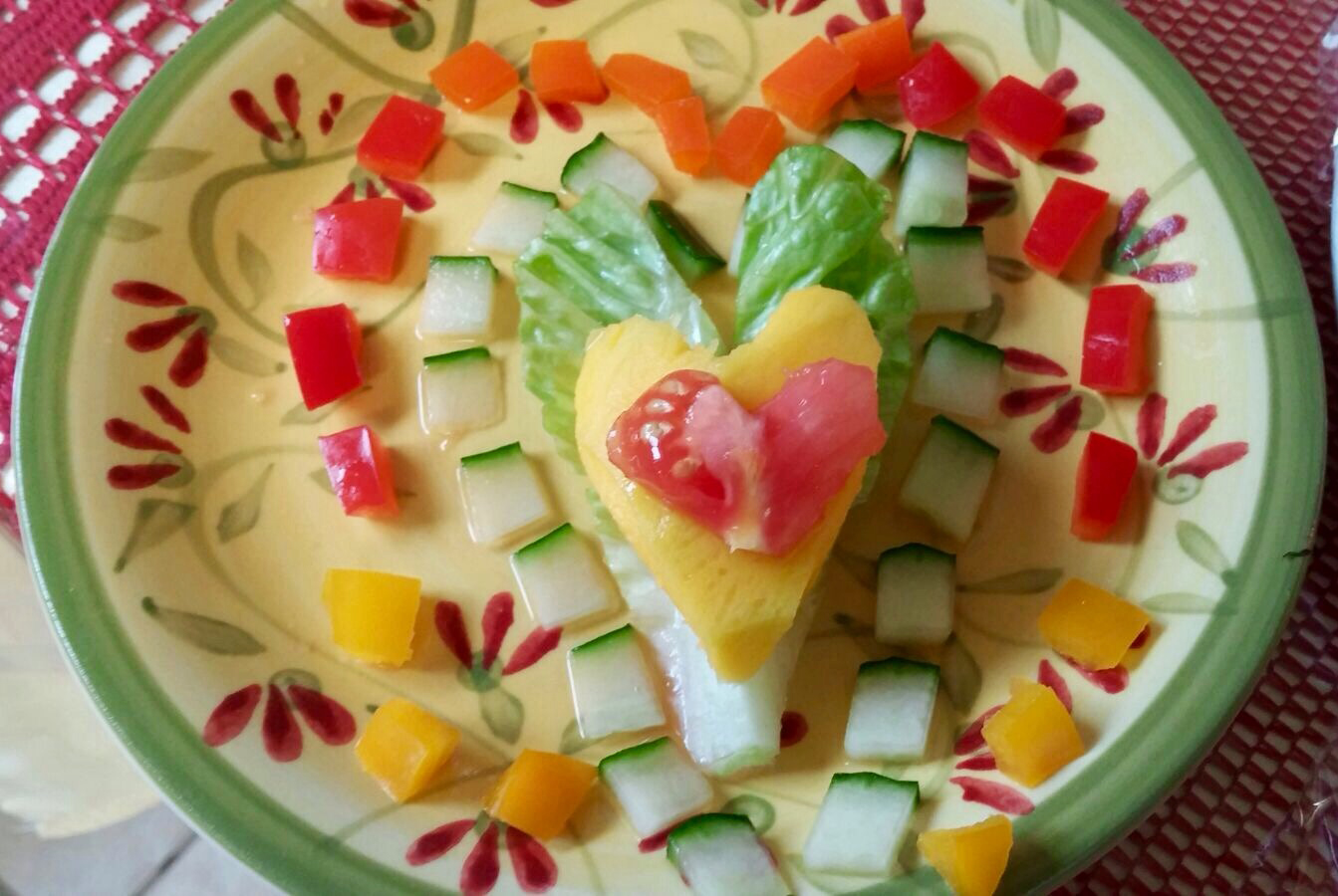 Carved and arranged fruits and vegetables forming a heart